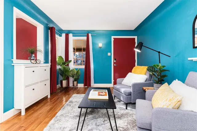 a living room with furniture a rug and a window