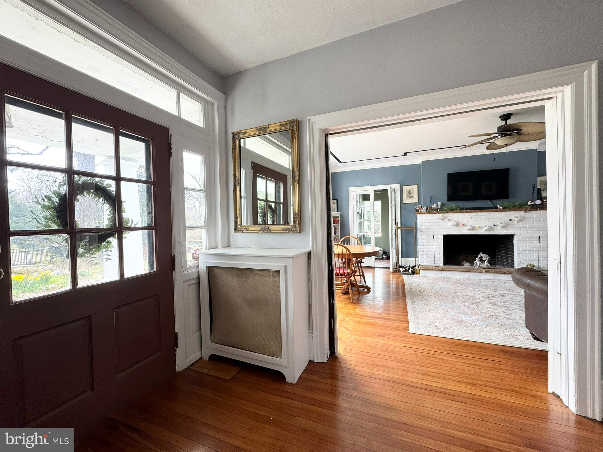 731 Yale Avenue Swarthmore, PA 19081 - Photo 3 of 35 a living room with a fireplace and a floor to ceiling window