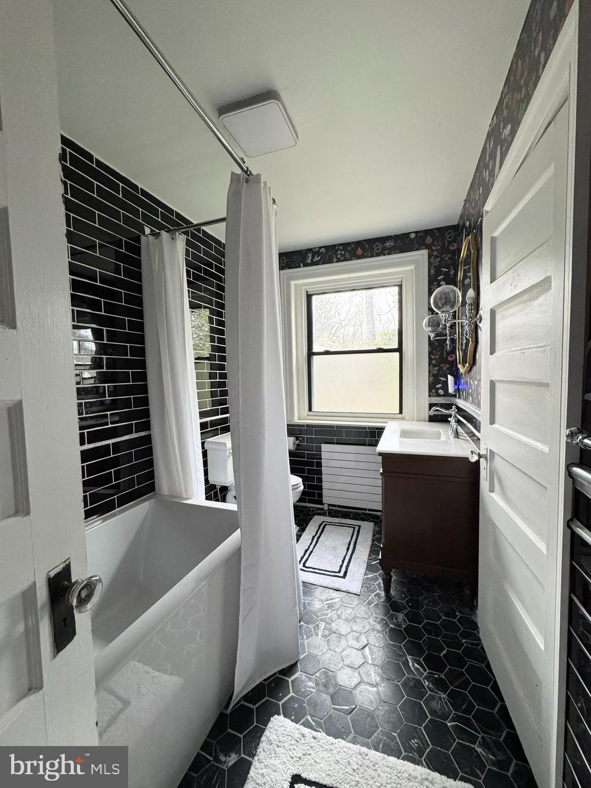 731 Yale Avenue Swarthmore, PA 19081 - Photo 32 of 35 a bathroom with a bathtub sink and window
