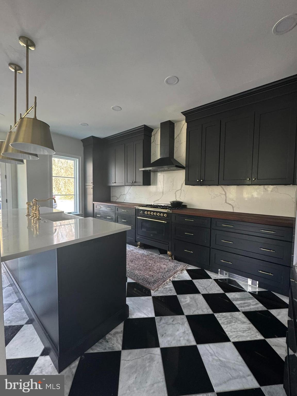 731 Yale Avenue Swarthmore, PA 19081 - Photo 6 of 35 a kitchen with a sink a stove a microwave and cabinets