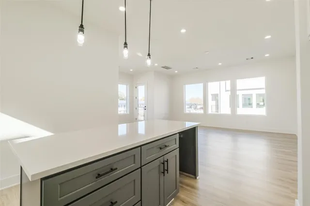 a view of a kitchen and a window in the room