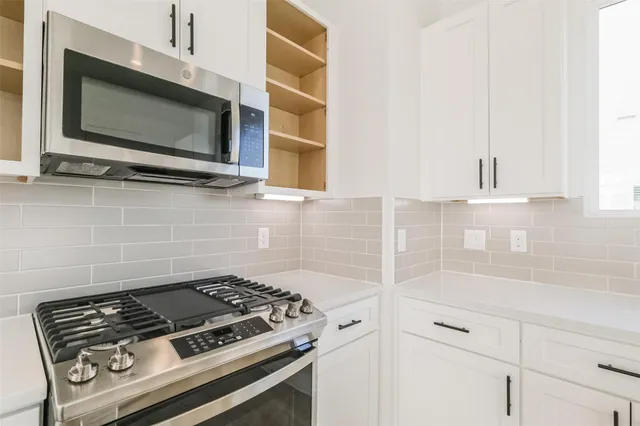 a kitchen with a stove and a microwave