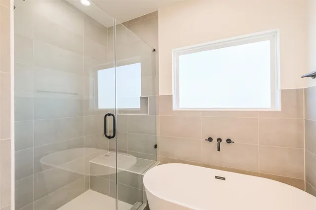 a bathroom with a bathtub and shower