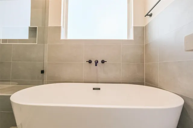 a white bath tub sitting in a bathroom