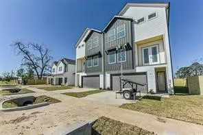 a view of a house with a patio and a yard