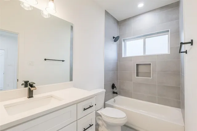 a bathroom with a sink a toilet and a bathtub