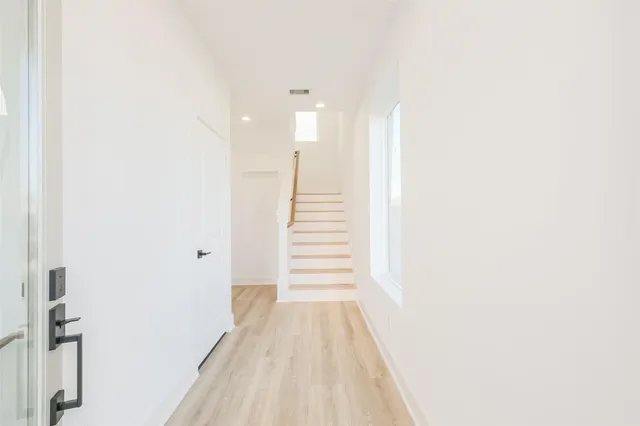 a view of a hallway with stairs