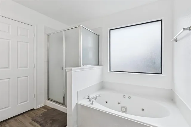 a bathroom with a sink toilet double vanity and shower