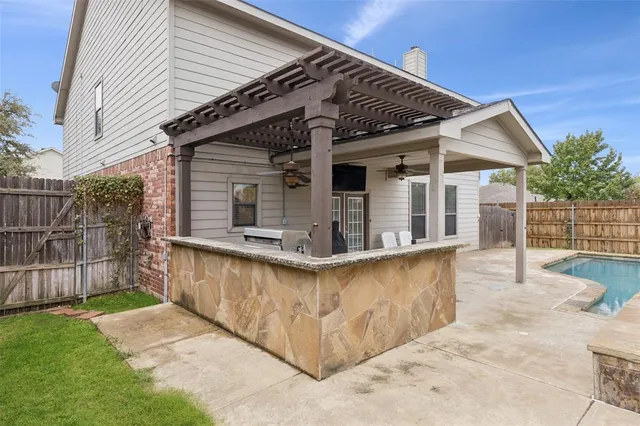 a view of a house with swimming pool and sitting area