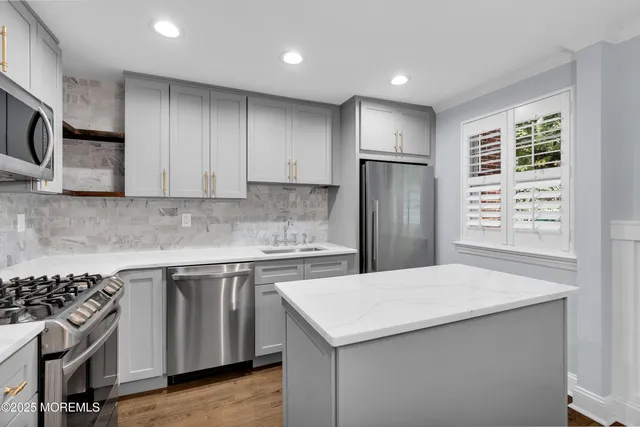 a kitchen with a stove a sink and a refrigerator
