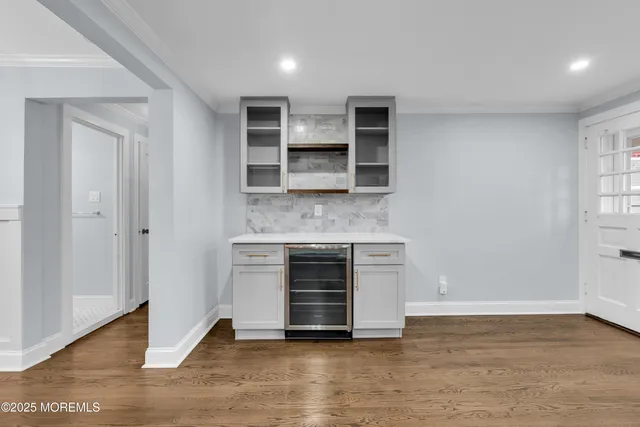 a view of an empty room with a fireplace and a window
