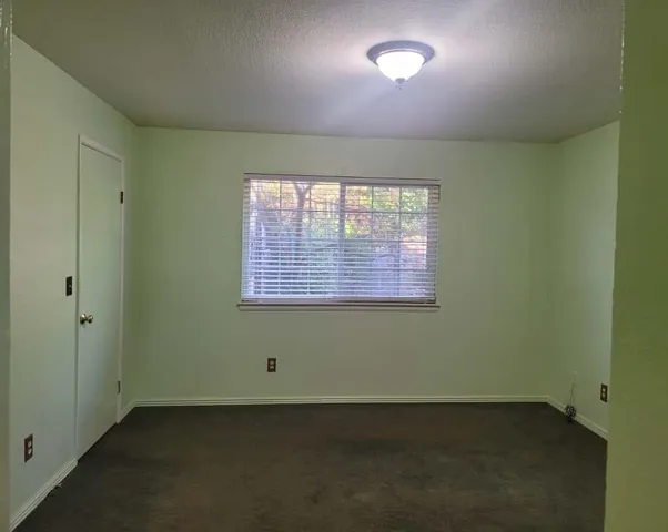 an empty room with a empty space and windows