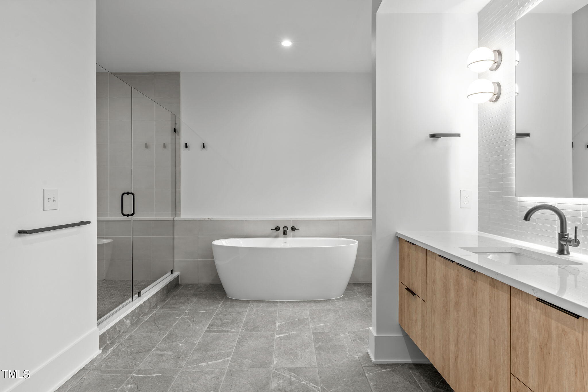 1406 Lyon Street, Unit 102 Raleigh, NC 27608 - Photo 21 of 57 a bathroom with a bathtub sink and mirror