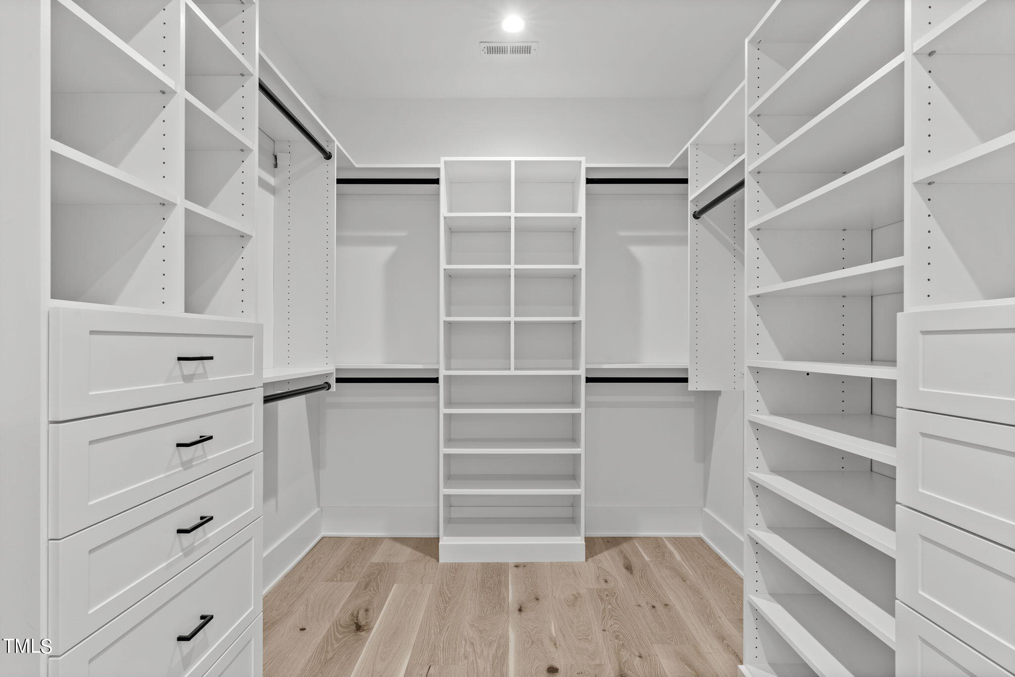 1406 Lyon Street, Unit 102 Raleigh, NC 27608 - Photo 23 of 57 a view of walk in closet with empty racks