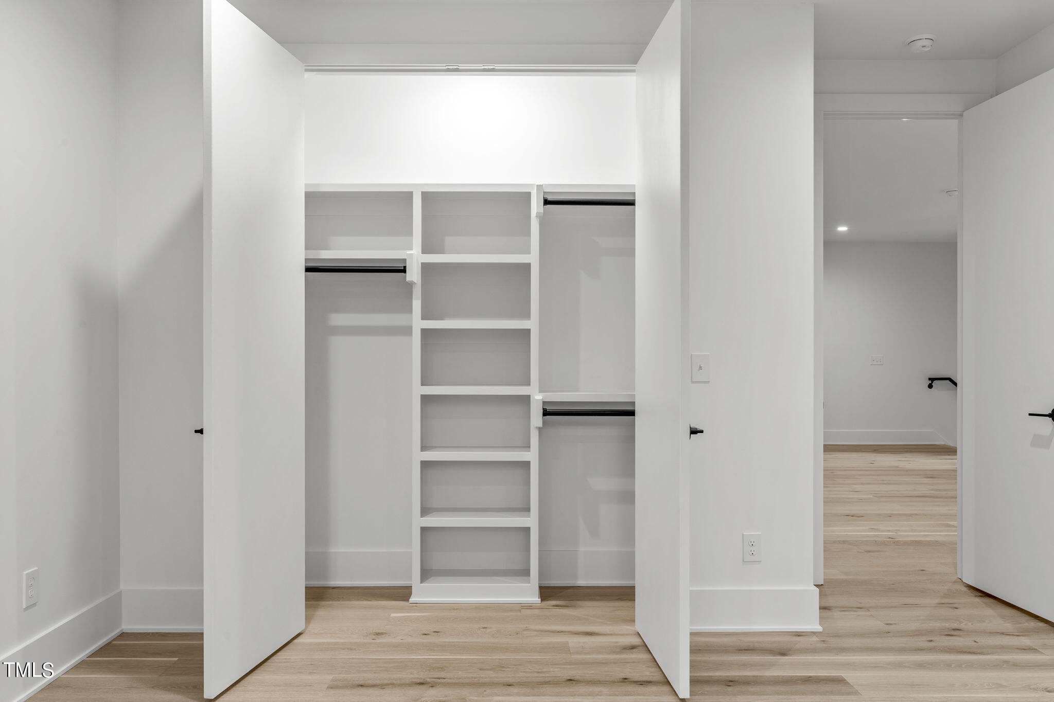 1406 Lyon Street, Unit 102 Raleigh, NC 27608 - Photo 27 of 57 a view of walk in closet with empty racks