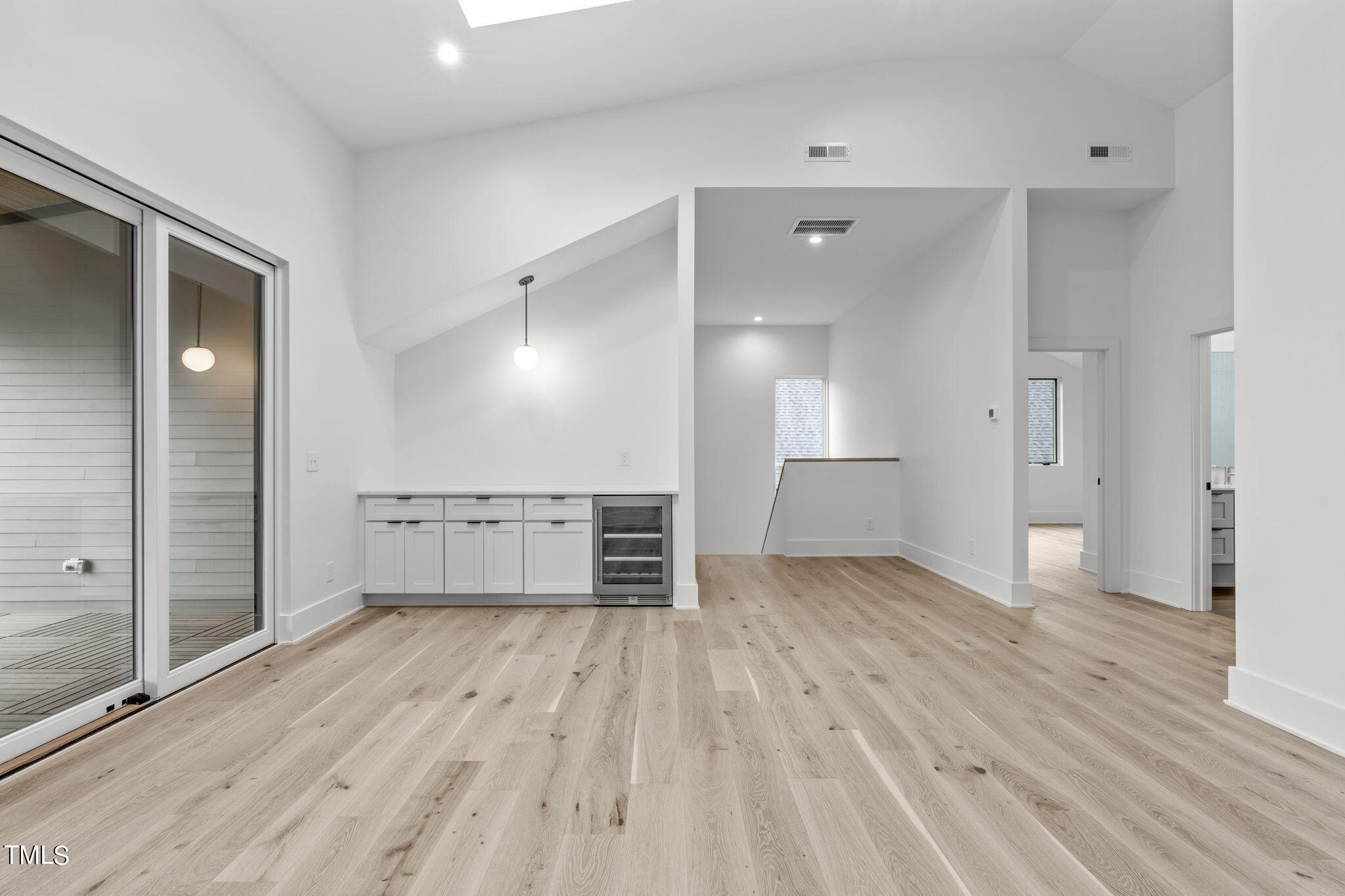 1406 Lyon Street, Unit 102 Raleigh, NC 27608 - Photo 35 of 57 an empty room with wooden floor and windows