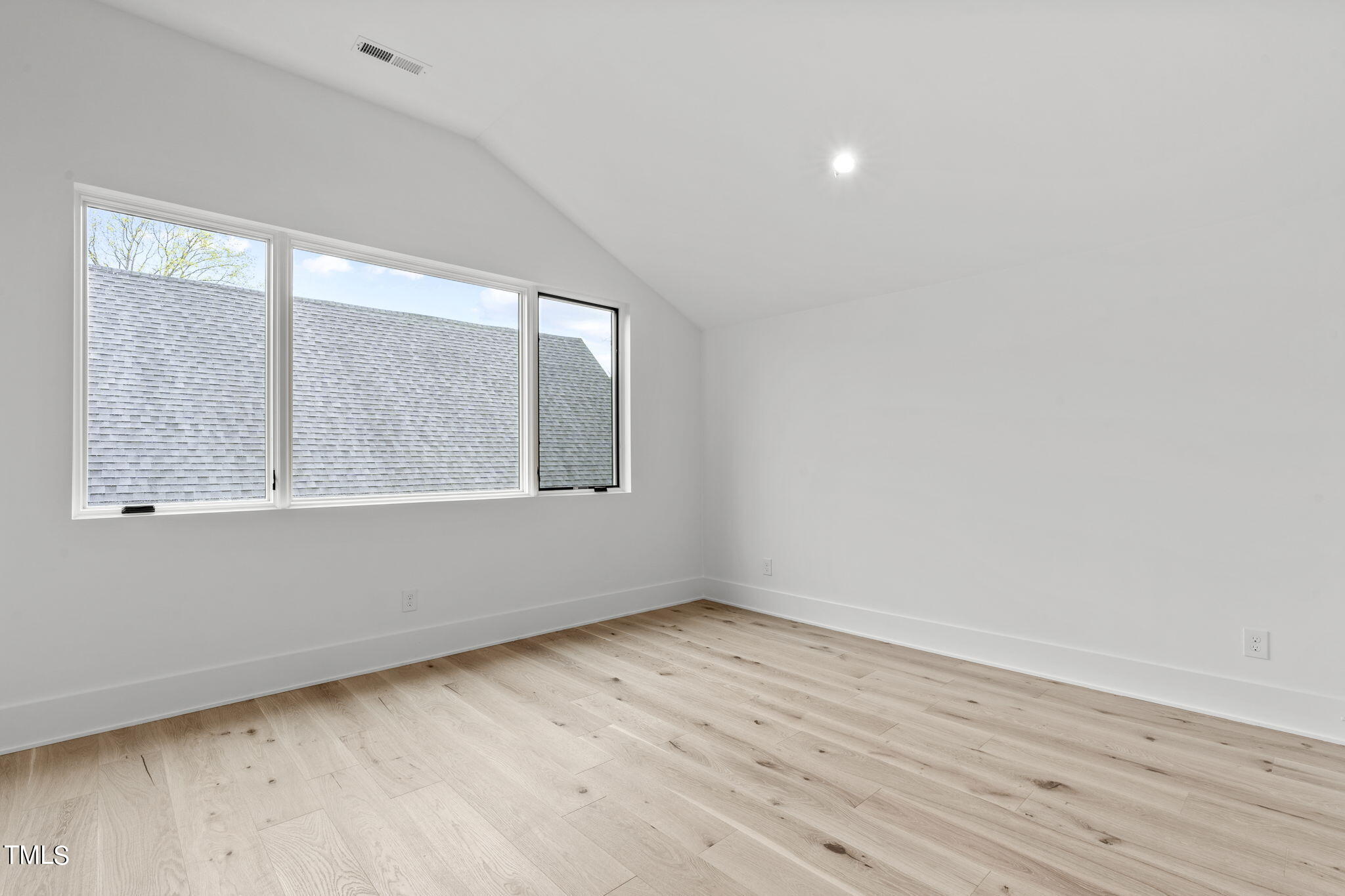 1406 Lyon Street, Unit 102 Raleigh, NC 27608 - Photo 36 of 57 wooden floor in an empty room with a window