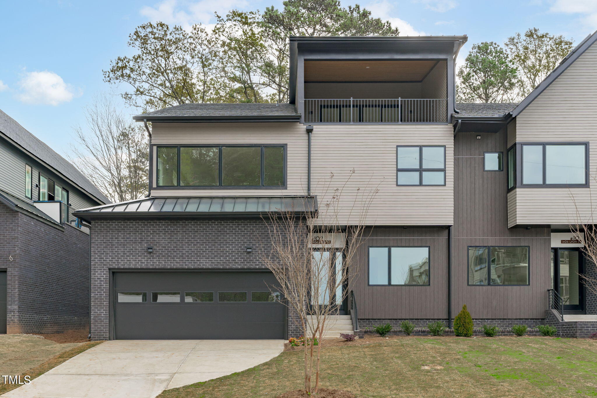 1406 Lyon Street, Unit 102 Raleigh, NC 27608 - Photo 38 of 57 a front view of a house with garage