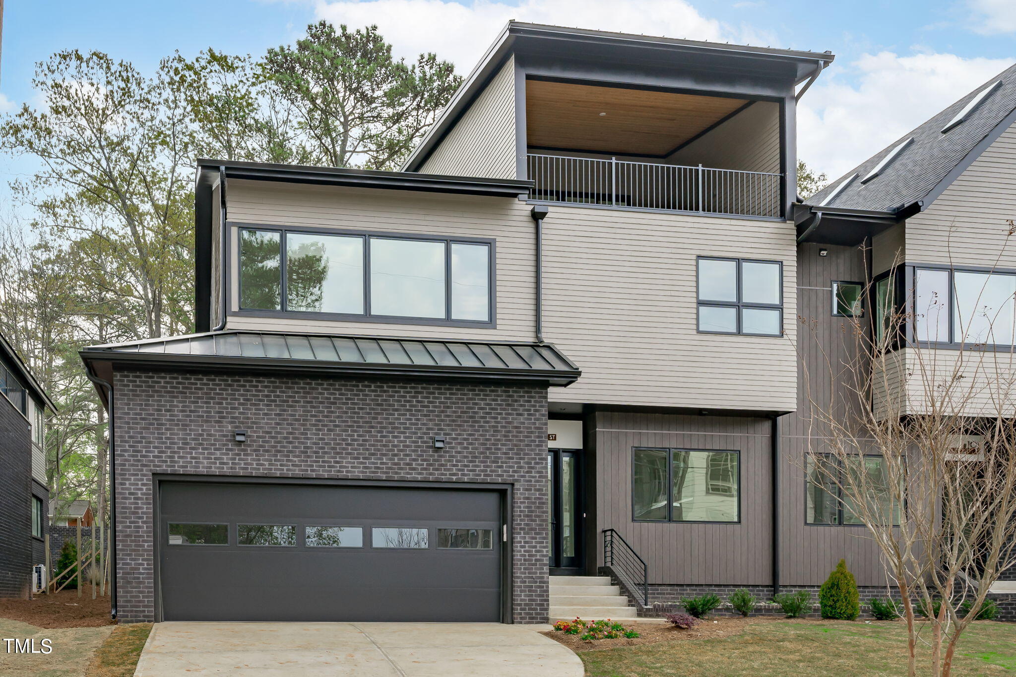 1406 Lyon Street, Unit 102 Raleigh, NC 27608 - Photo 39 of 57 a front view of a house with garage