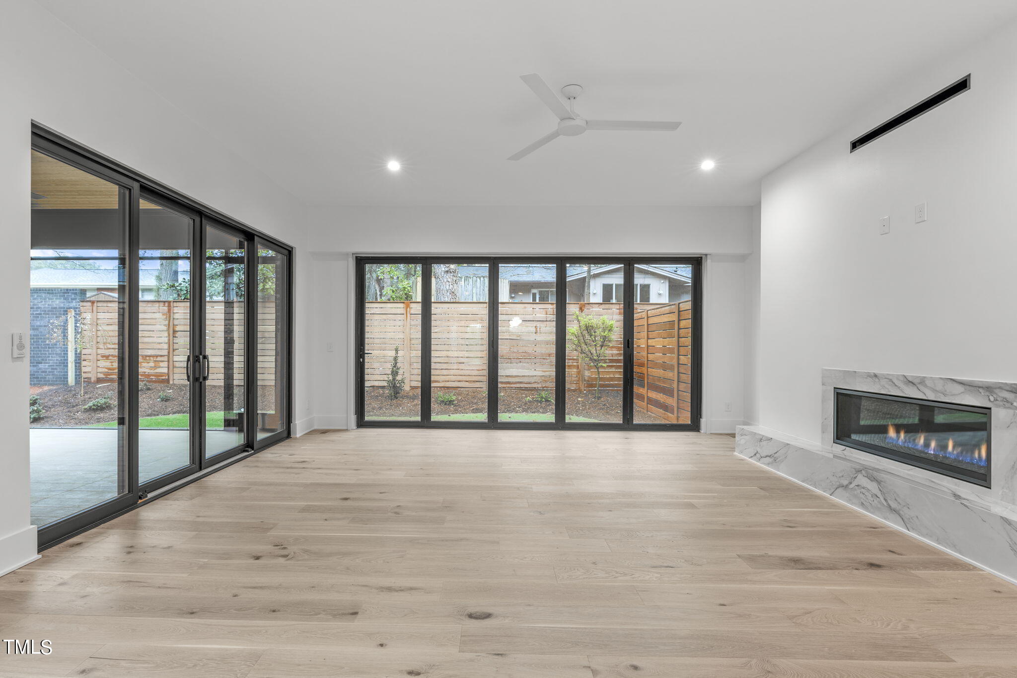 1406 Lyon Street, Unit 102 Raleigh, NC 27608 - Photo 6 of 57 a view of an empty room with a fireplace and a window