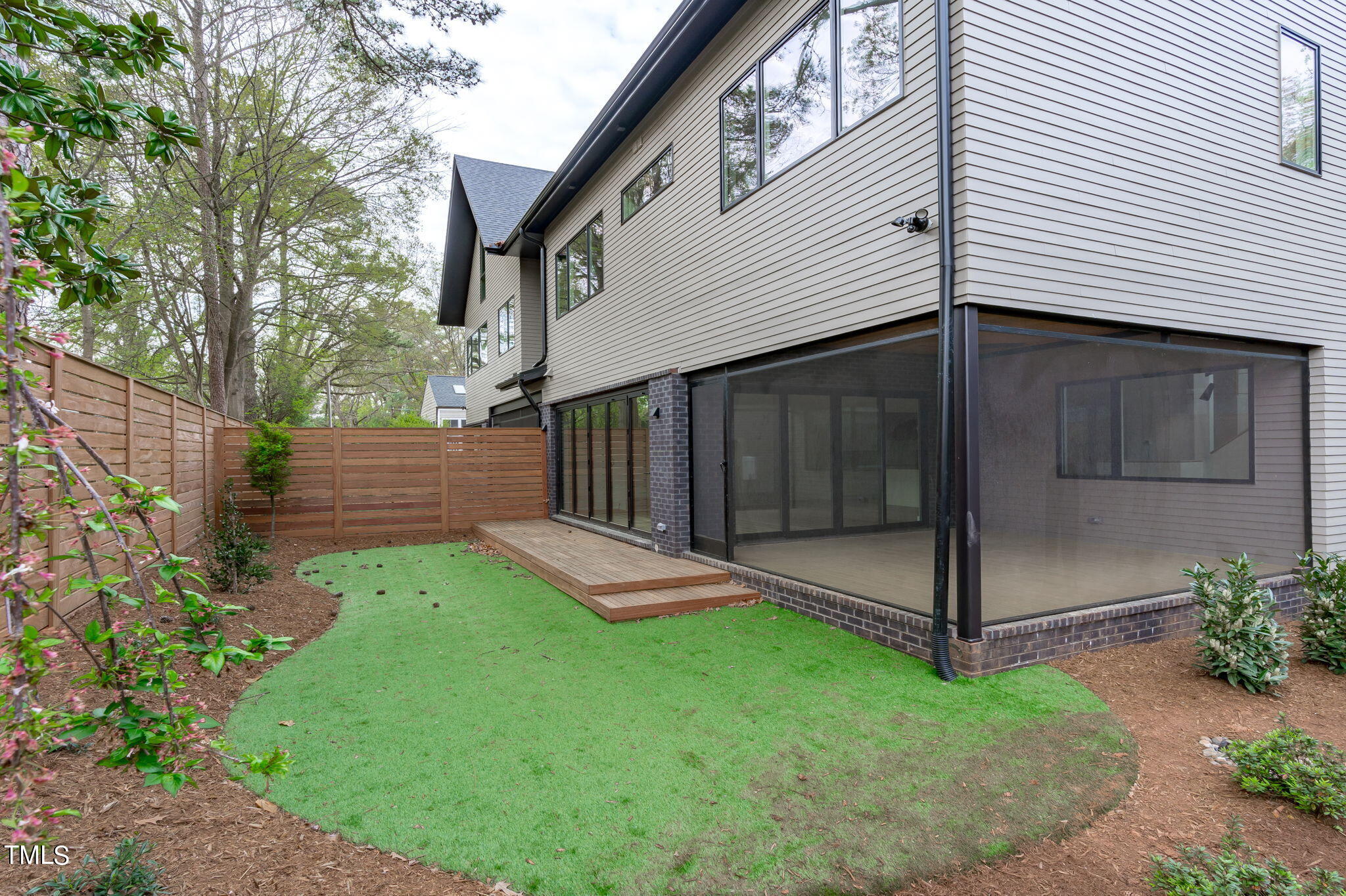 1406 Lyon Street, Unit 102 Raleigh, NC 27608 - Photo 10 of 57 a view of backyard with a garden and plants