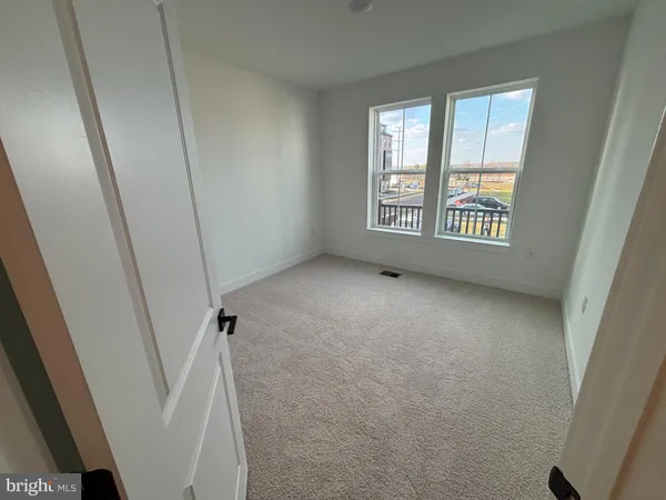 a view of room with window and a floor to ceiling window