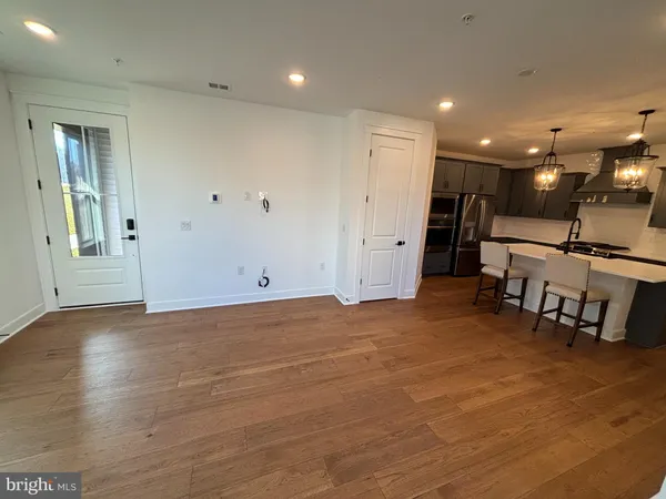 a view of a room with wooden floor and furniture