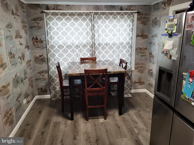 a dining room with furniture and wooden floor