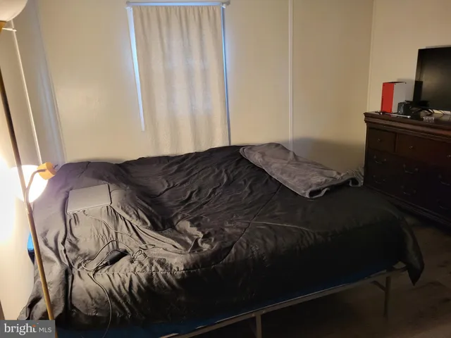 a bed sitting in a bedroom next to a window