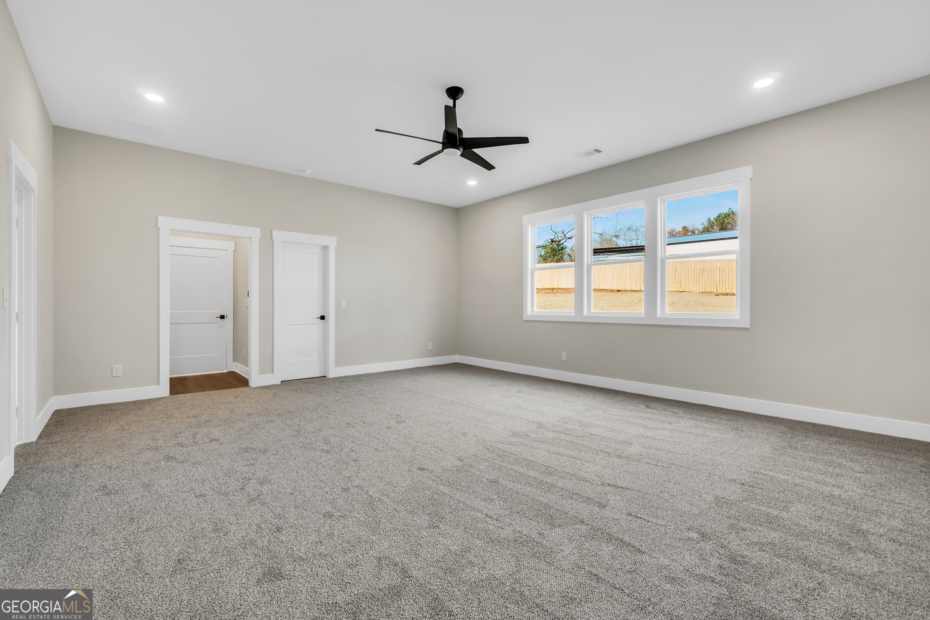 277 East Knight Road McDonough, GA 30252 - Photo 11 of 23 an empty room with chandelier fan and windows