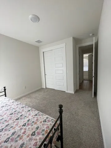 a view of a room that has a bed in it