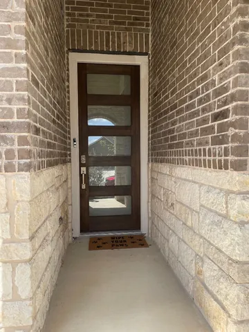 a kitchen with stainless steel appliances a refrigerator a sink a stove a microwave and wooden floors