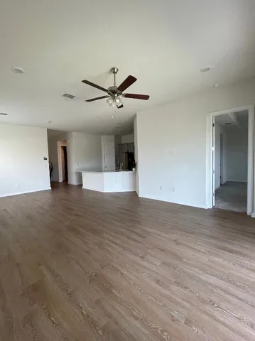 a view of a kitchen with wooden floor and a sink