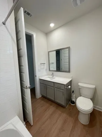 a bathroom with a sink a toilet and mirror