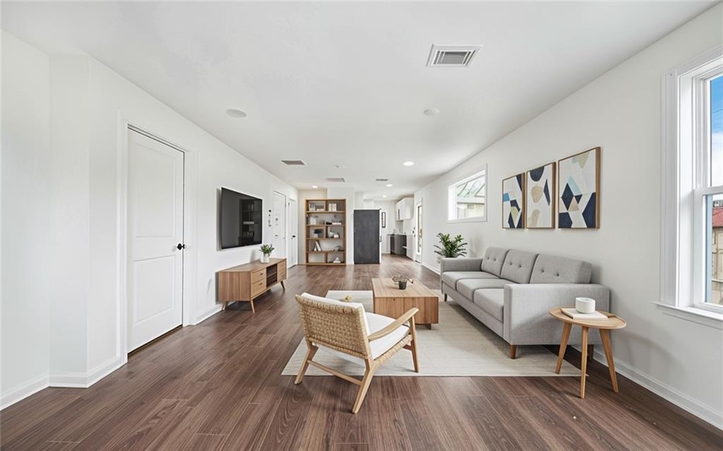 1 Lamar Avenue Southwest Atlanta, GA 30310 - Photo 3 of 11 a living room with furniture a flat screen tv and a wooden floor