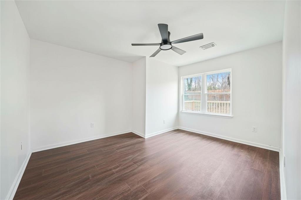 1 Lamar Avenue Southwest Atlanta, GA 30310 - Photo 4 of 11 a view of an empty room with wooden floor and a window