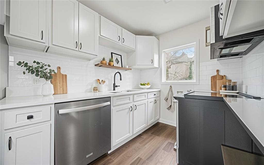 1 Lamar Avenue Southwest Atlanta, GA 30310 - Photo 5 of 11 a kitchen with cabinets a window and appliances