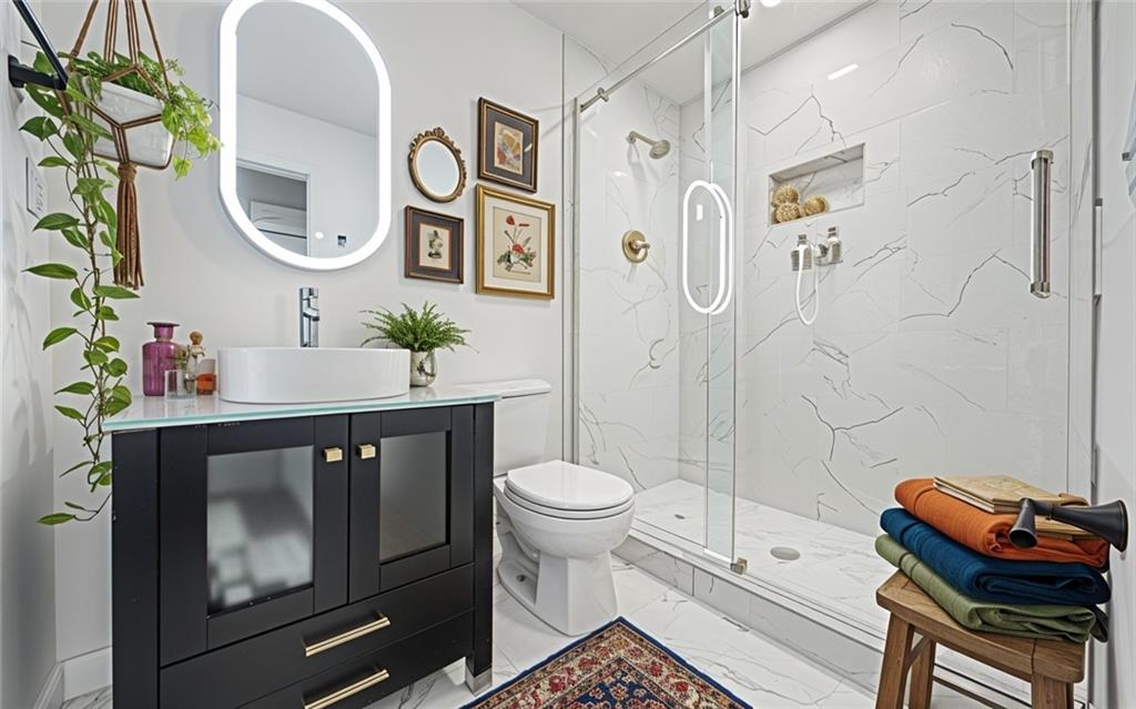 1 Lamar Avenue Southwest Atlanta, GA 30310 - Photo 8 of 11 a bathroom with a toilet sink and mirror