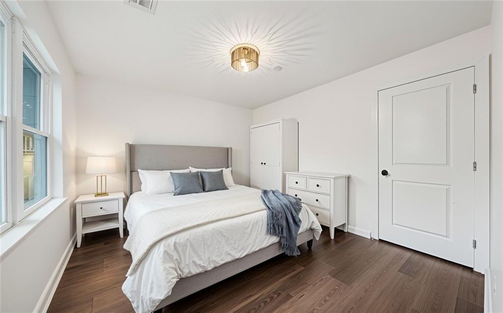 1 Lamar Avenue Southwest Atlanta, GA 30310 - Photo 9 of 11 a bedroom with a bed and a chandelier