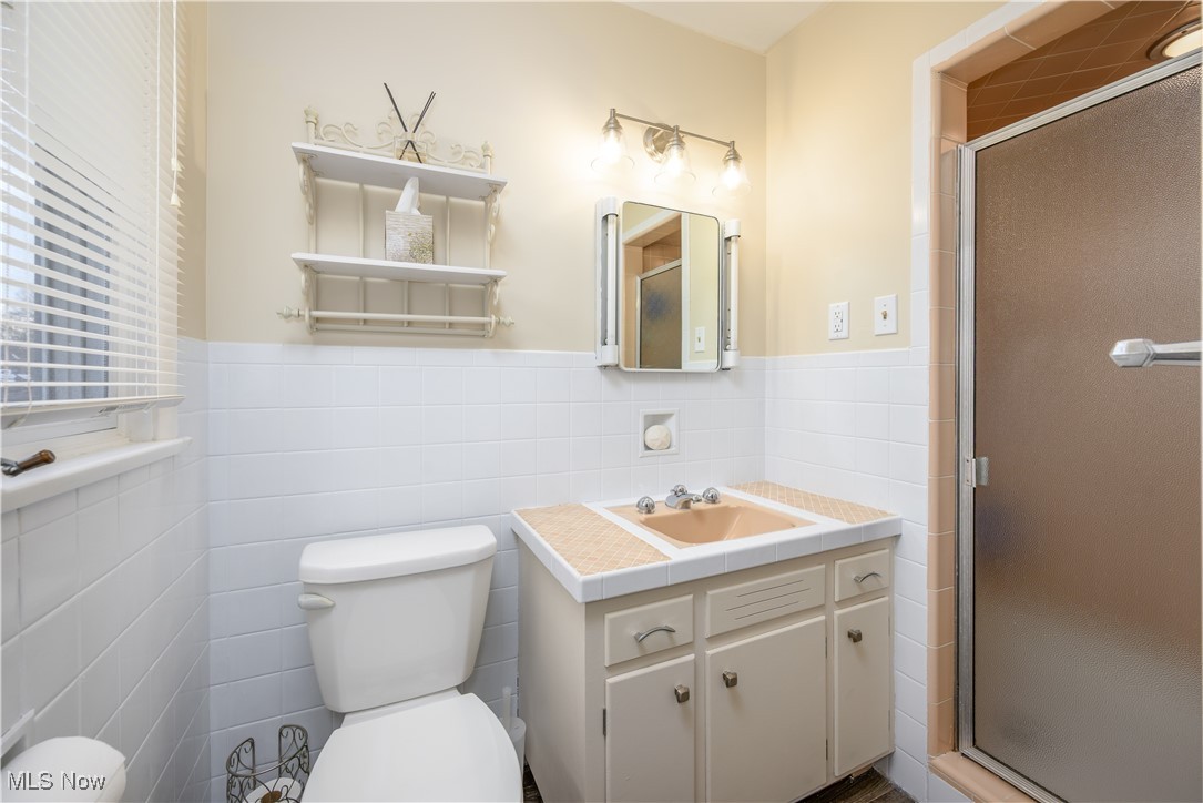 1989 Larchmont Road Akron, OH 44313 - Photo 23 of 38 Bathroom with a shower stall, toilet, and vanity