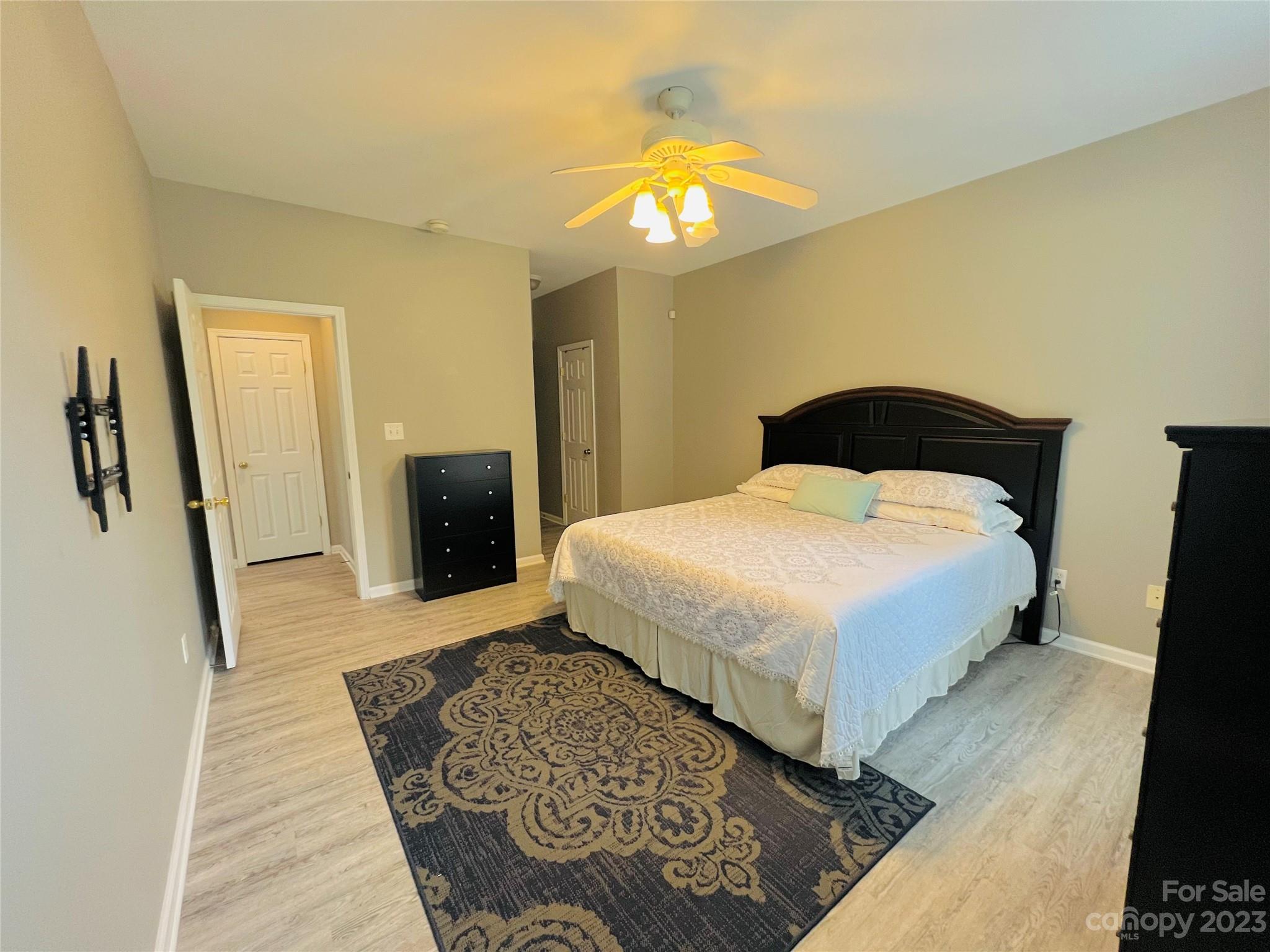 117 Forest Ridge Road Mooresville, NC 28117 - Photo 12 of 40 a bedroom with a large bed and a rug