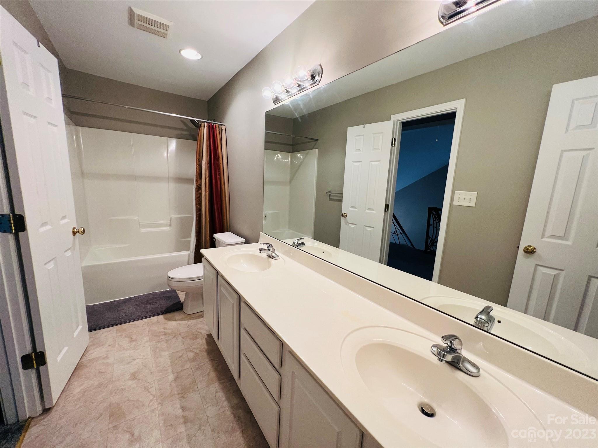 117 Forest Ridge Road Mooresville, NC 28117 - Photo 26 of 40 a bathroom with a double vanity sink a toilet and shower