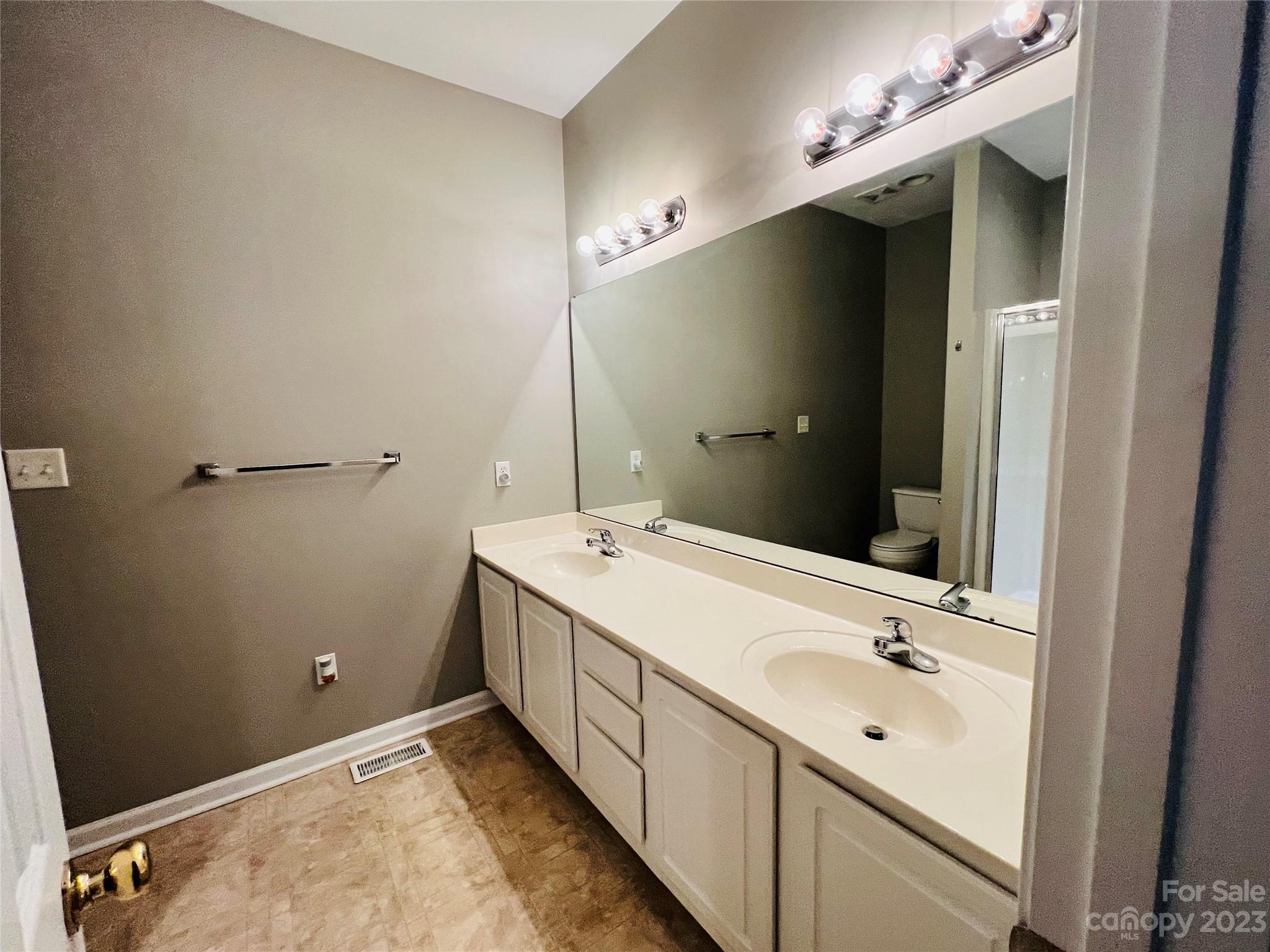 117 Forest Ridge Road Mooresville, NC 28117 - Photo 27 of 40 a bathroom with a double vanity sink and mirror