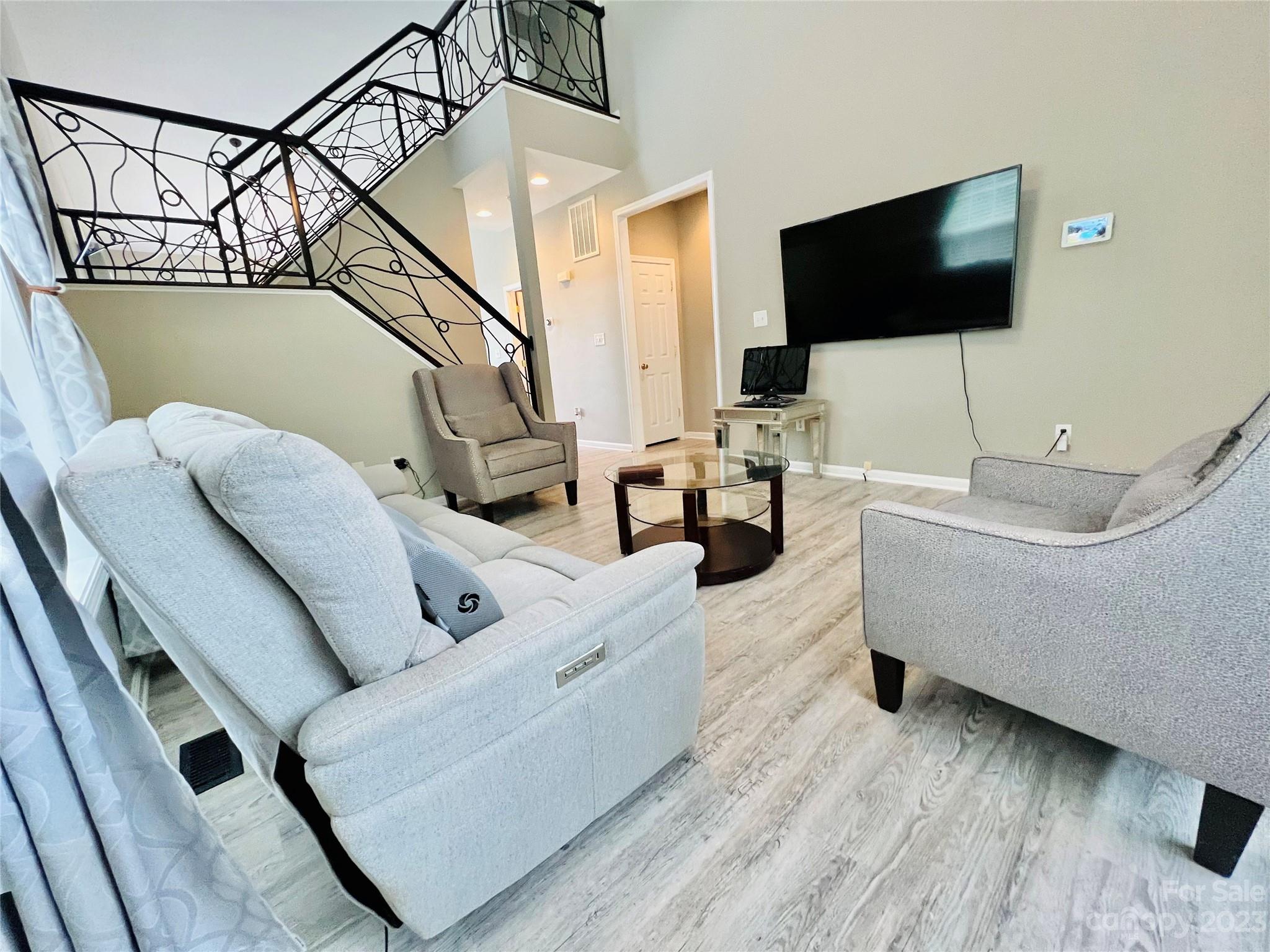117 Forest Ridge Road Mooresville, NC 28117 - Photo 4 of 40 a living room with furniture and a flat screen tv