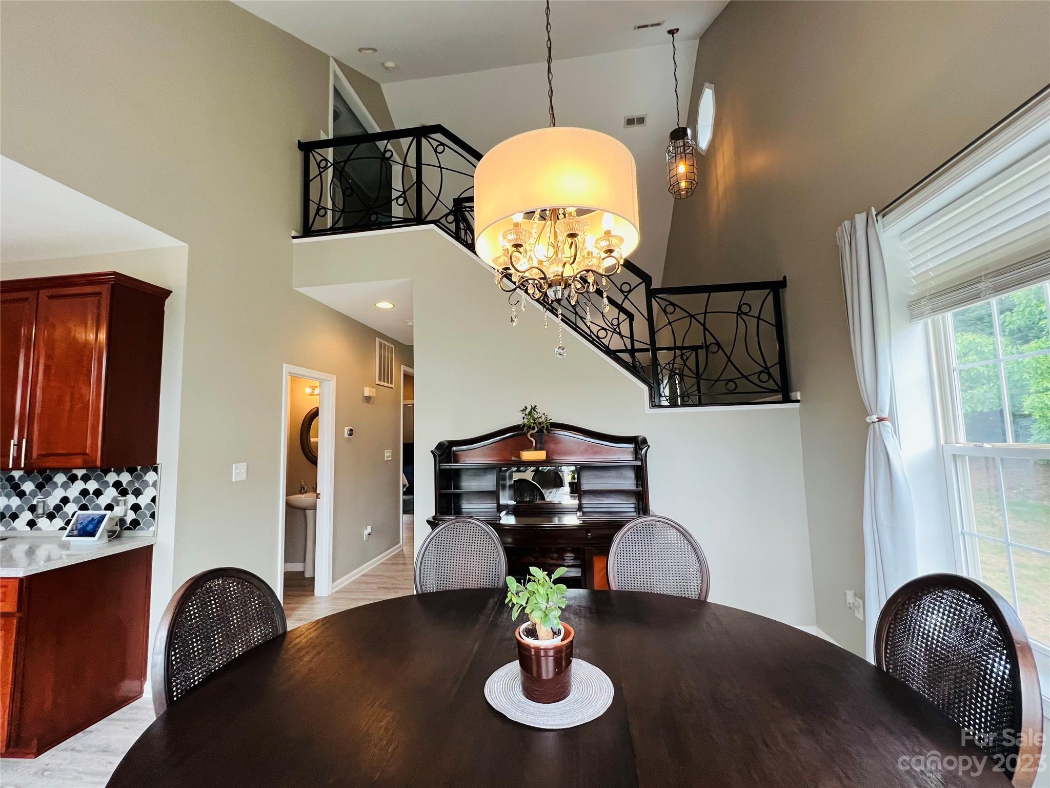 117 Forest Ridge Road Mooresville, NC 28117 - Photo 7 of 40 a living room with furniture and a chandelier