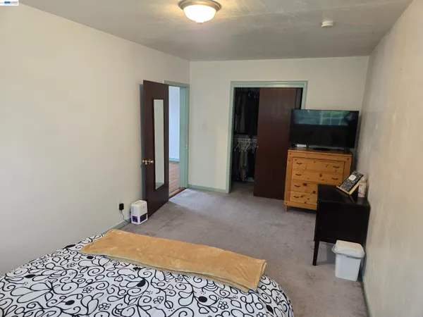 a bedroom with a bed and gym equipment