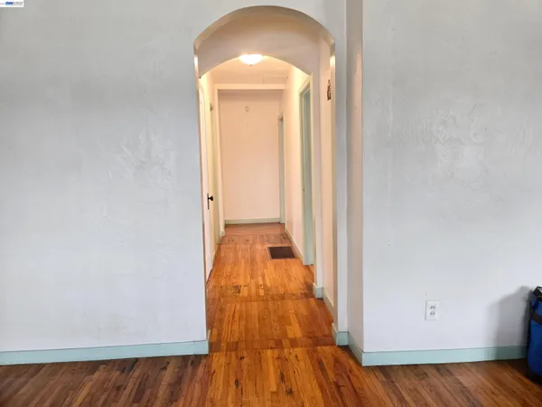view of a bedroom with wooden floor and entrance