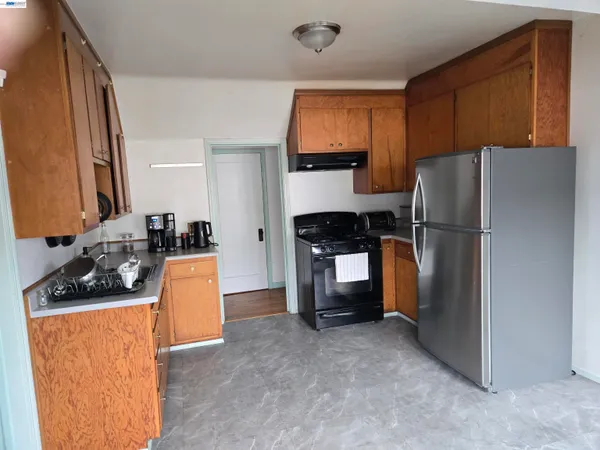 a kitchen with stainless steel appliances a refrigerator stove and sink