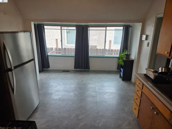 a kitchen with window and refrigerator