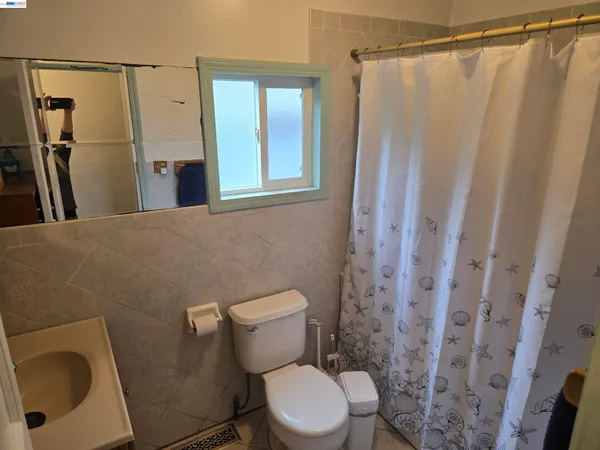 a white toilet sitting next to a small sink